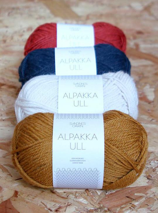 Four balls of Alpakka Ull by Sandnes Garn in Ochre, White, Navy and Red